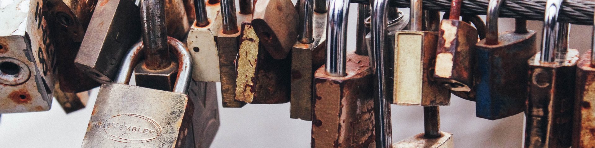 shallow focus photography of padlocks in steel cable