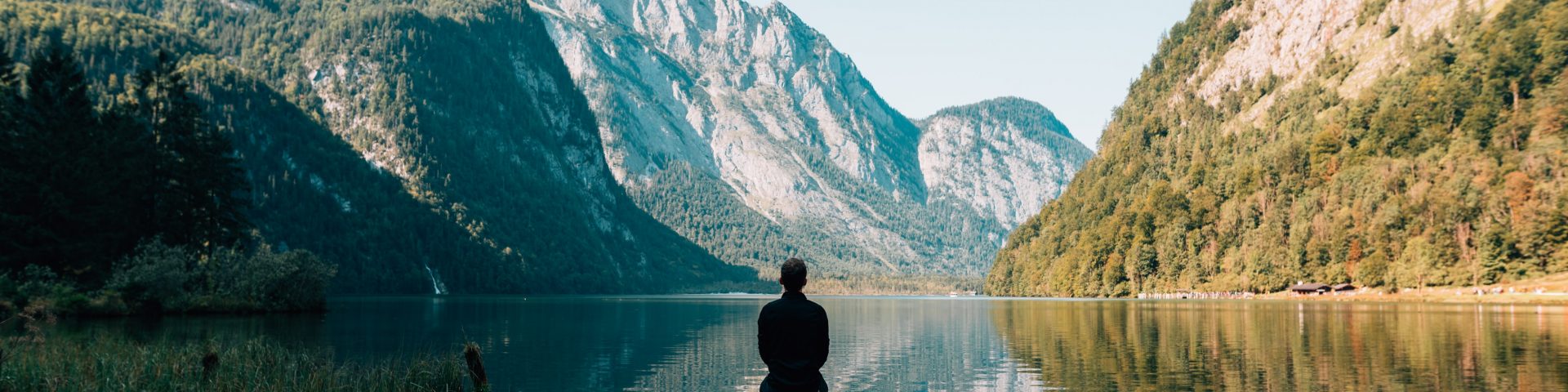 enjoy life - man sitting on gray dock