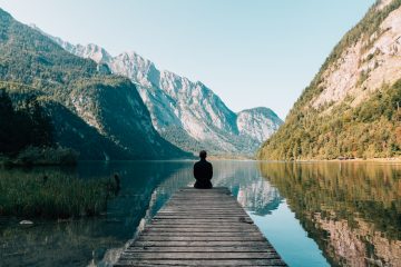 enjoy life - man sitting on gray dock